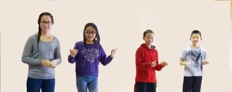 Four students standing in a row, counting on their fingers