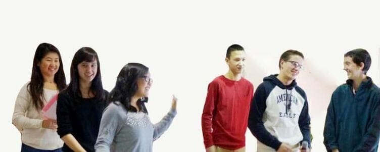Two groups of older students talking together