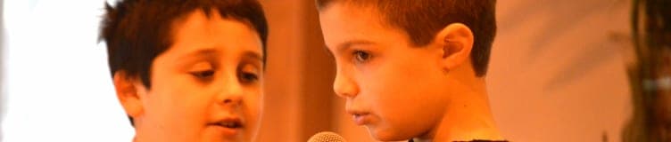 Two students sharing a microphone at a school event
