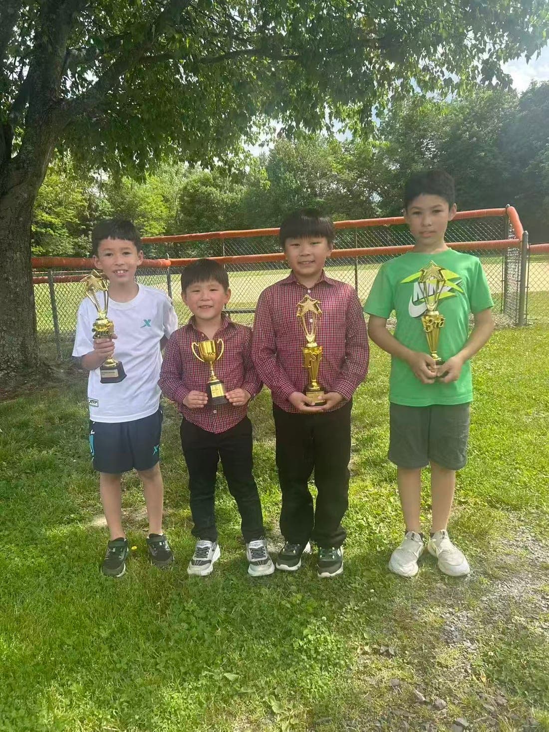Four students holding the trophies they won